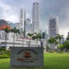 white high rise building near green grass field during daytime