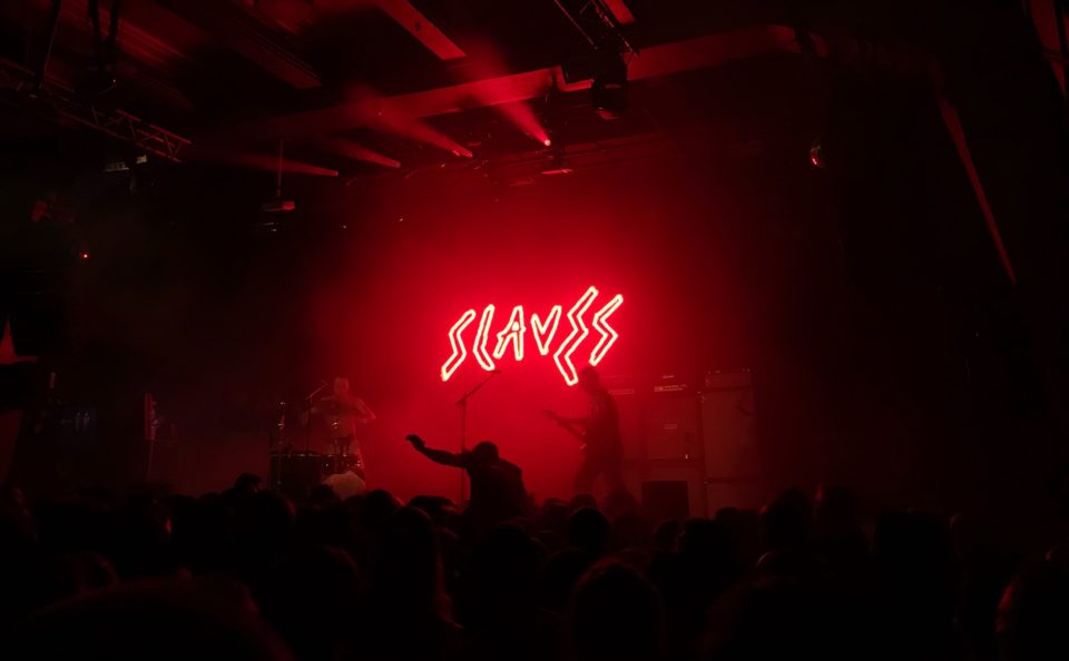 Slaves lighted signage on stage