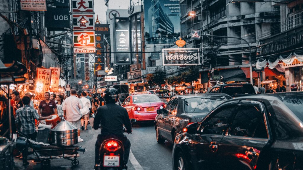 crowded street with cars passing by